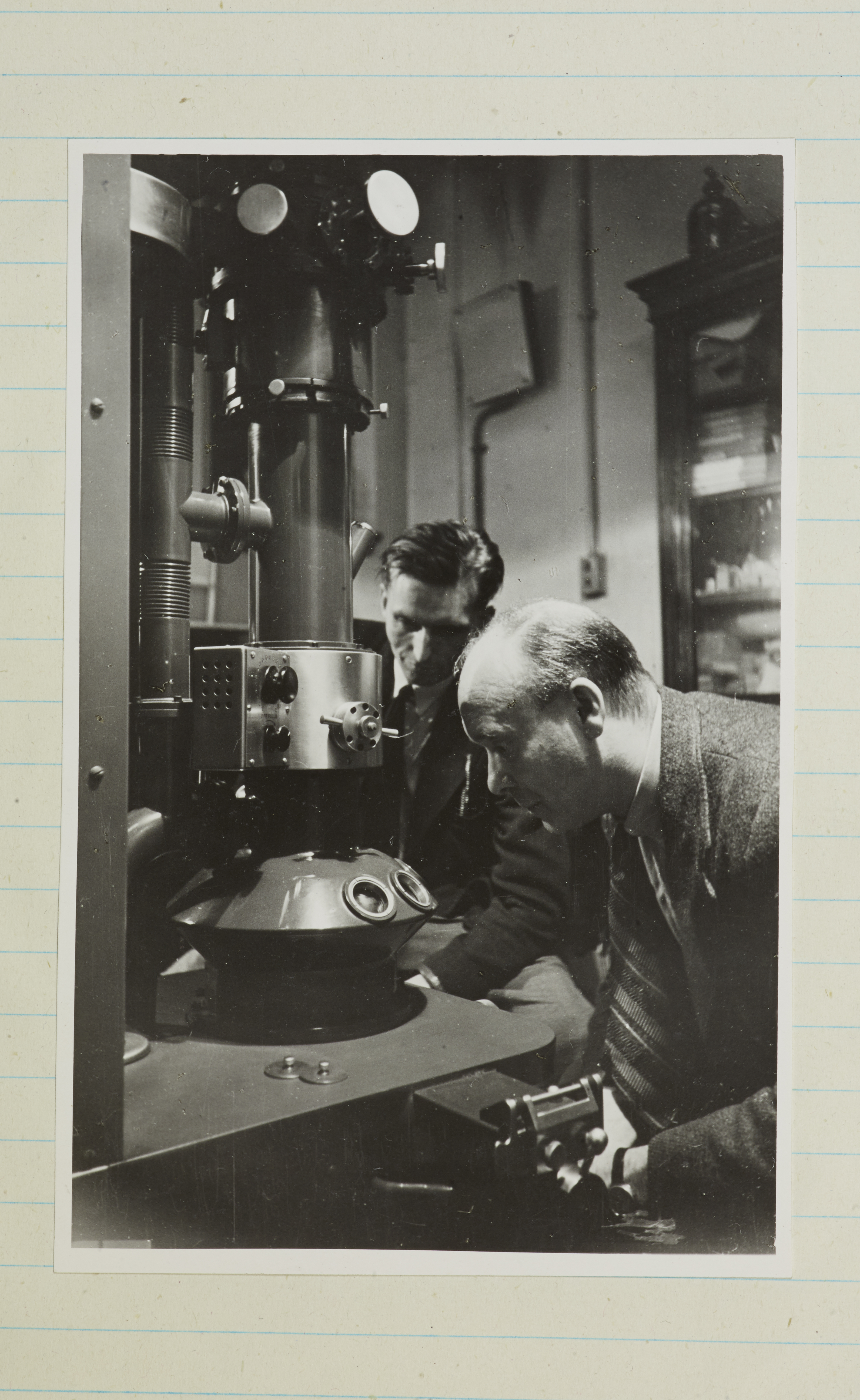 Physicist William Astbury peers down one of the very first electron microscopes to arrive in the UK, in 1943